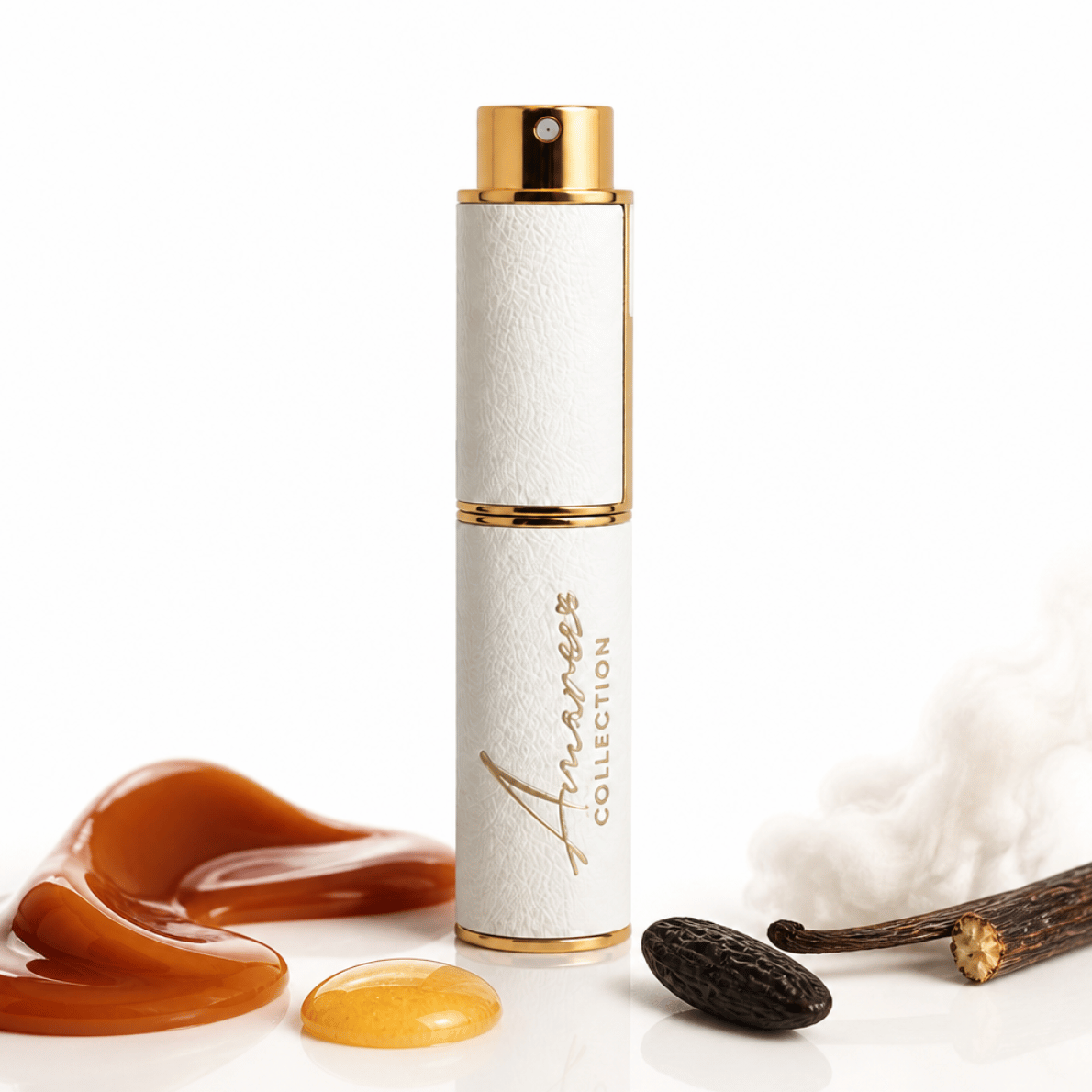 A white cylindrical perfume atomizer spray bottle with gold trim and a gold cap, standing upright on a white surface. The bottle is branded &