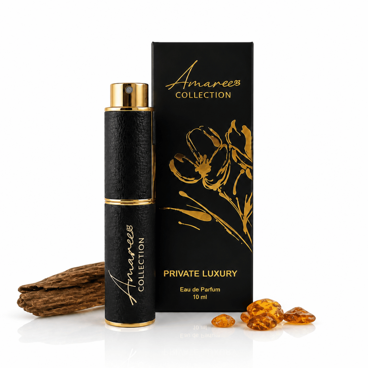 A 10 ml bottle of Amaree Collection Private Luxury Eau de Parfum next to its black and gold box, styled with a piece of wood and amber crystals on a white background.