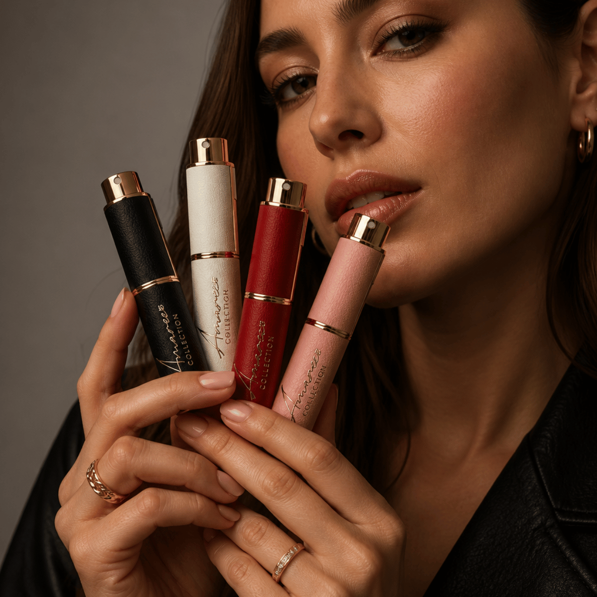 Female holding 4 different refillable perfumes 10ml