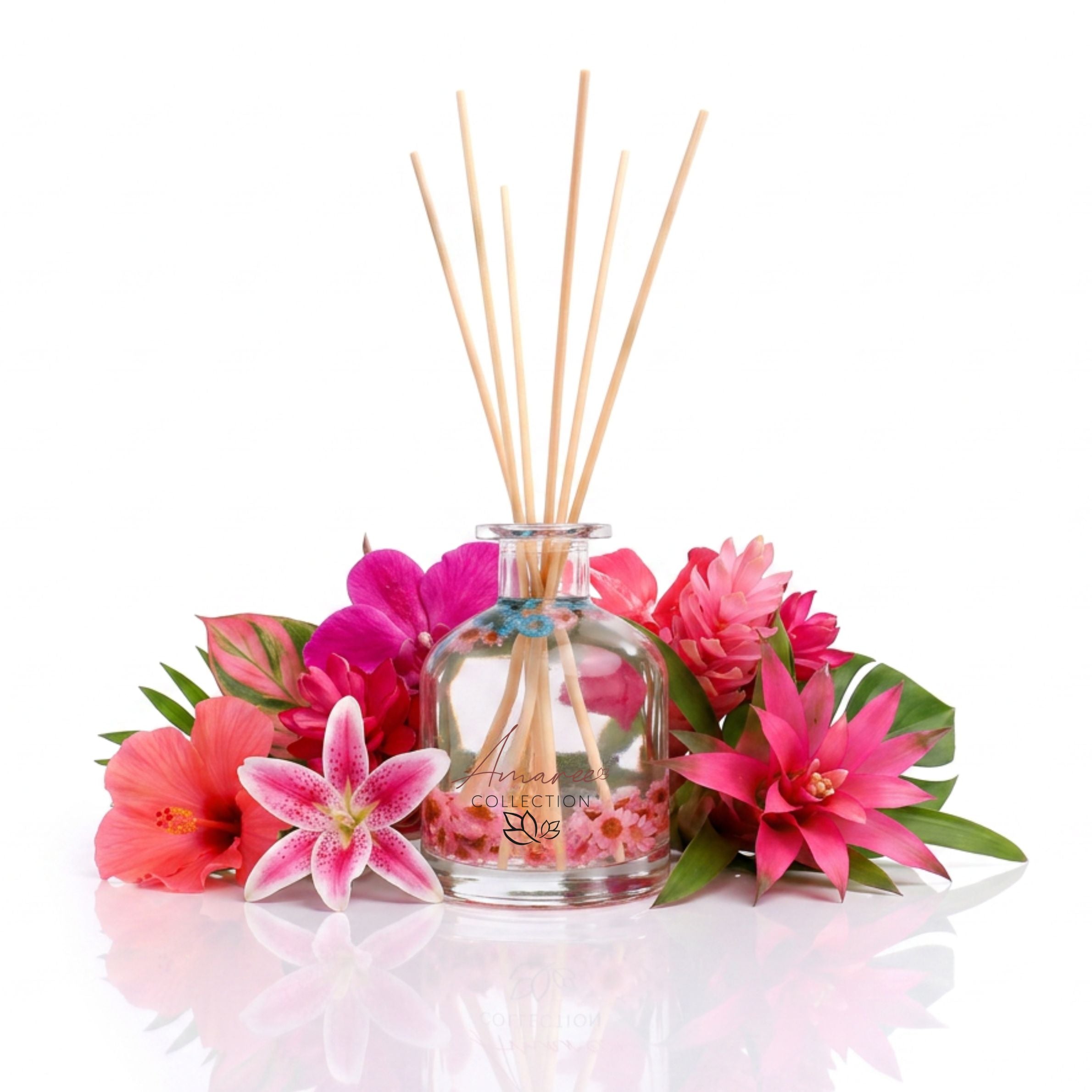 Aromatherapy diffuser with wooden sticks surrounded by pink flowers on a white background