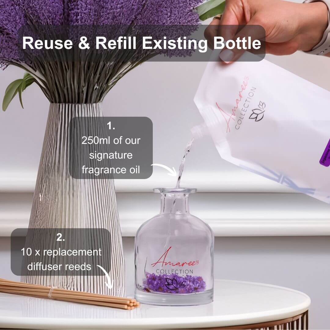 Japanese Honeysuckle Reed Diffuser Refill 250ml being poured into a diffuser bottle with lavender flowers.