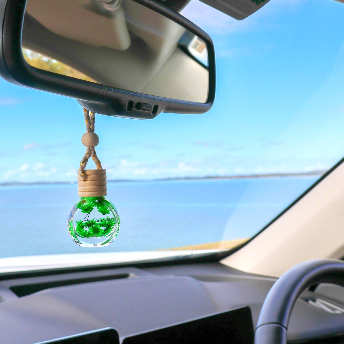 hanging car air freshener with green flowers and the scent of lemongrass and persian lime