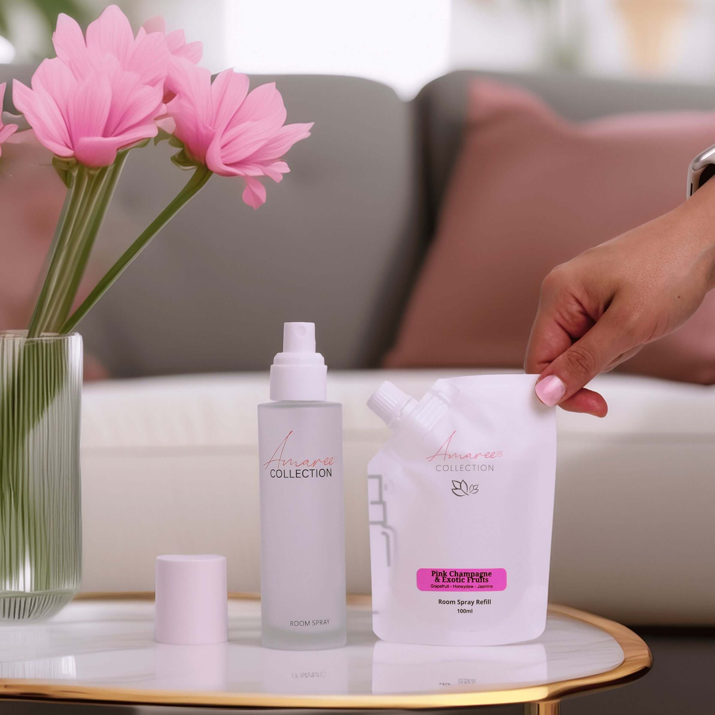 Pink Champagne & Exotic Fruits Room Spray Refill 100ml with floral arrangement and stylish packaging on elegant table.