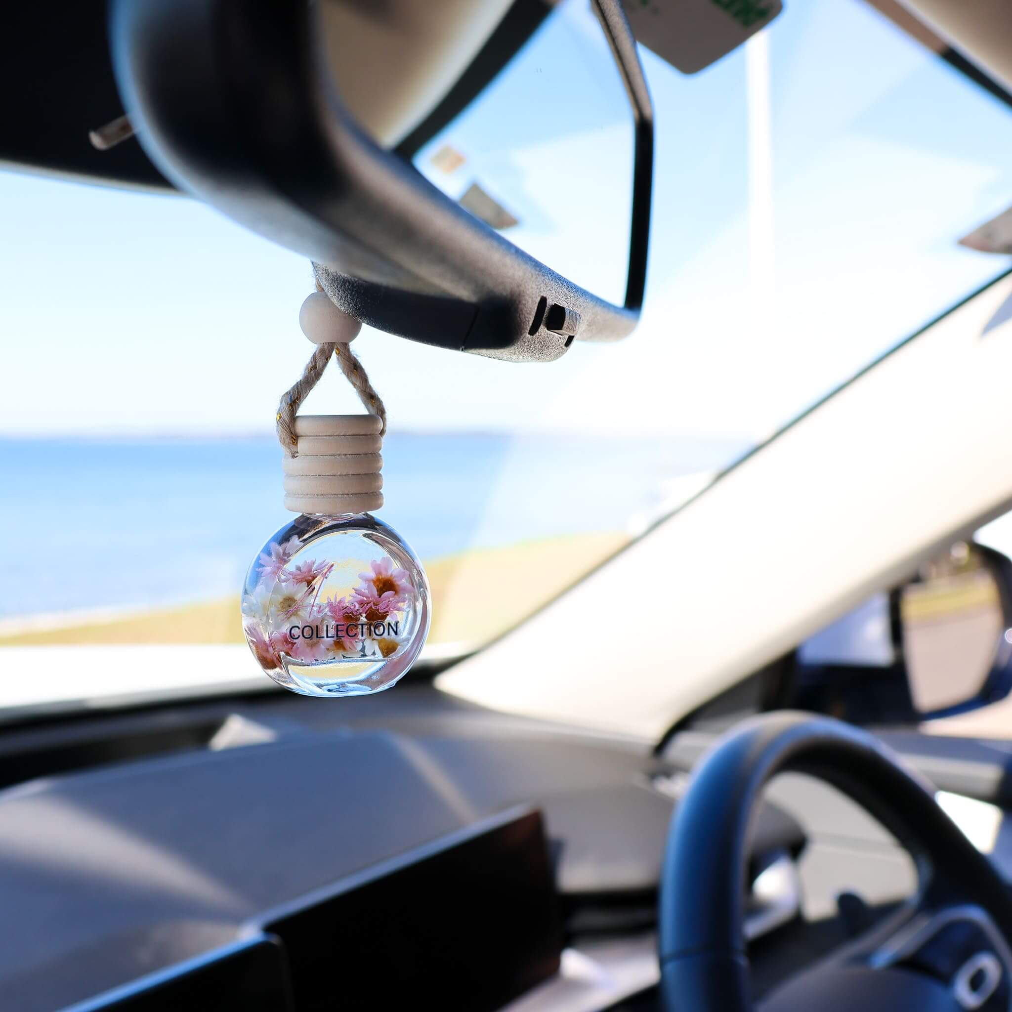 Sheer Lily & White Rose Car Diffuser hanging in a modern car creating an elegant, soft and graceful fresh driving atmosphere