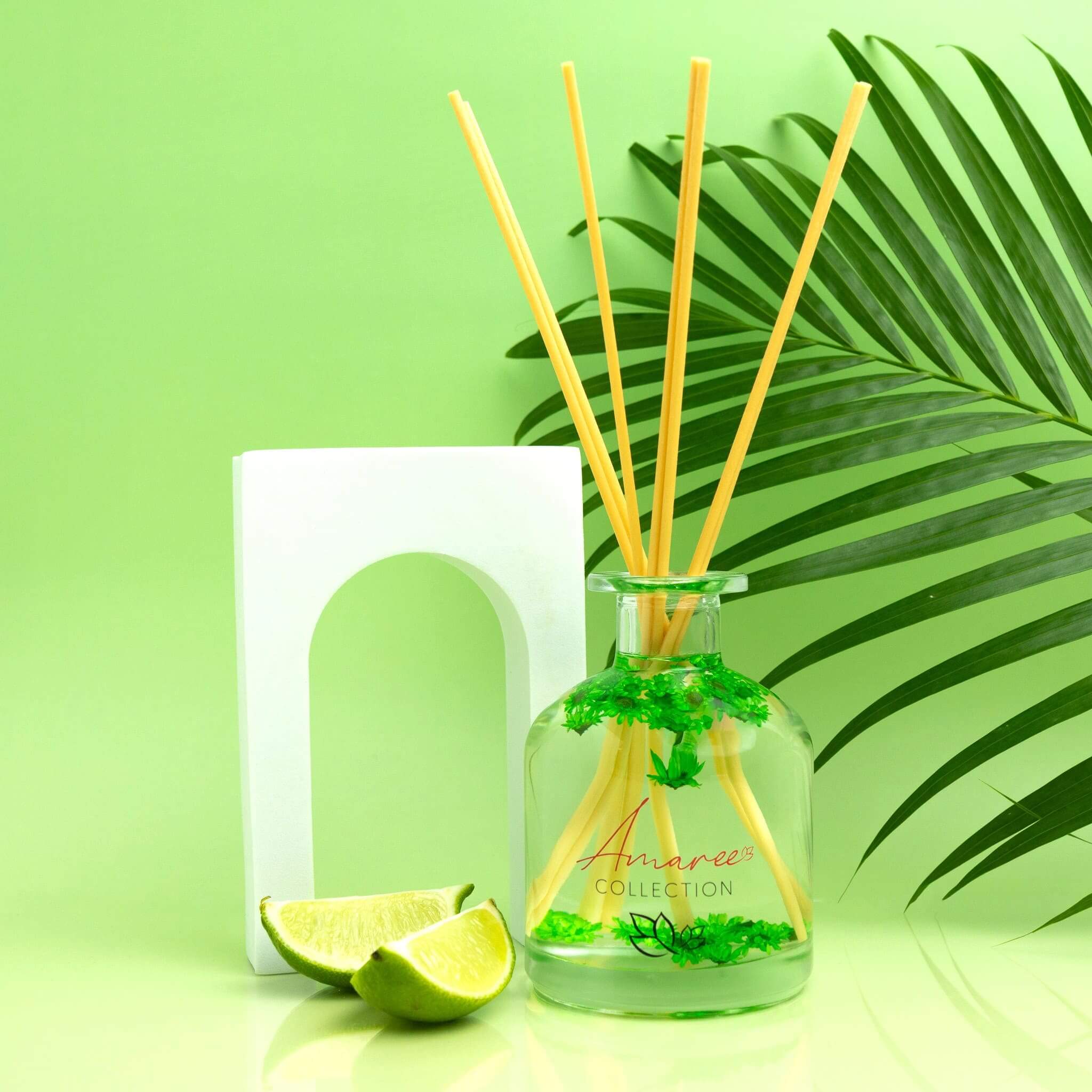 Lemongrass & Persian Lime Reed Diffuser 250ml displayed with lime and green leaves on a vibrant background.