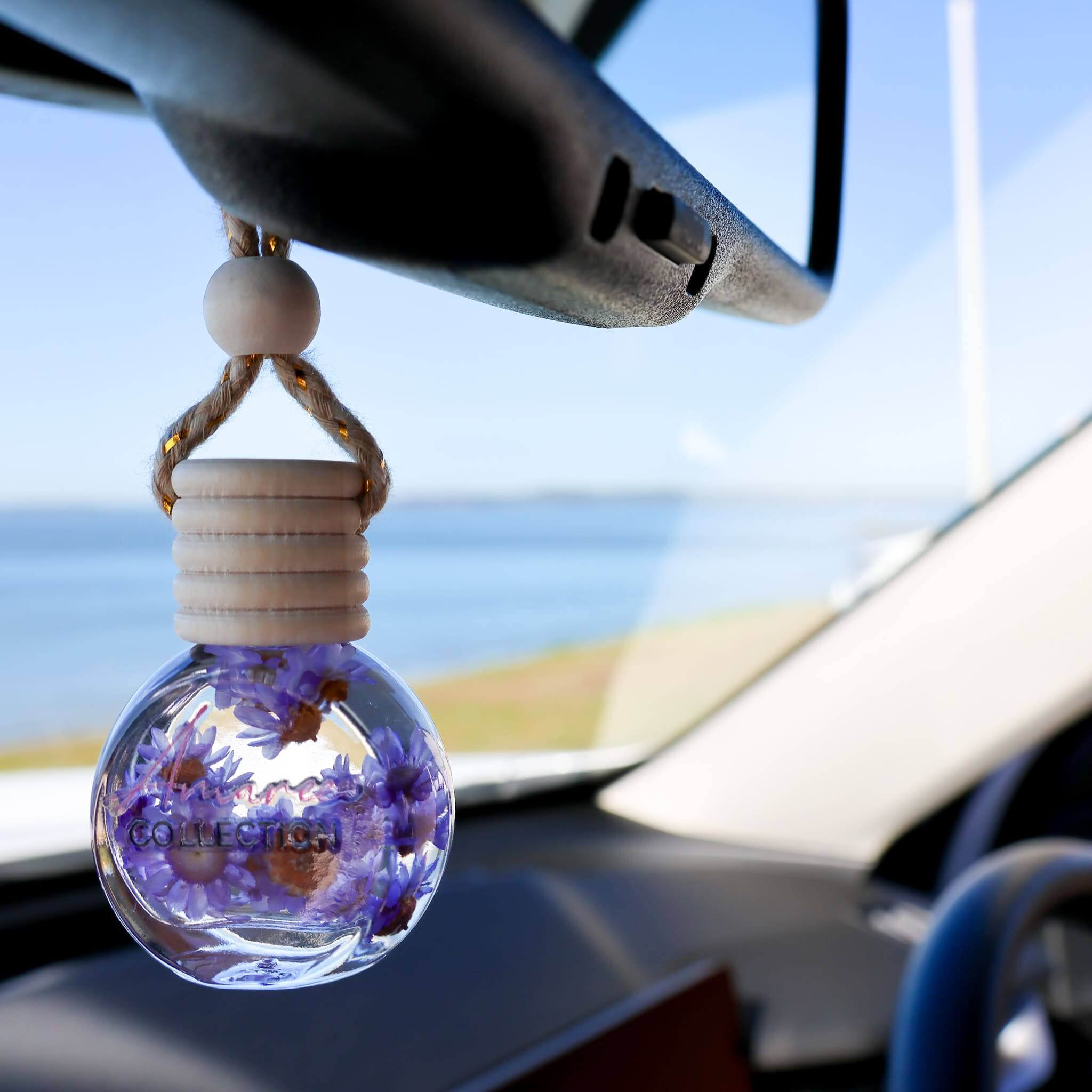 Black Amber & Lavender Car Diffuser Refill hanging in car, calming floral woody scent eco-friendly refill for fresh driving atmosphere