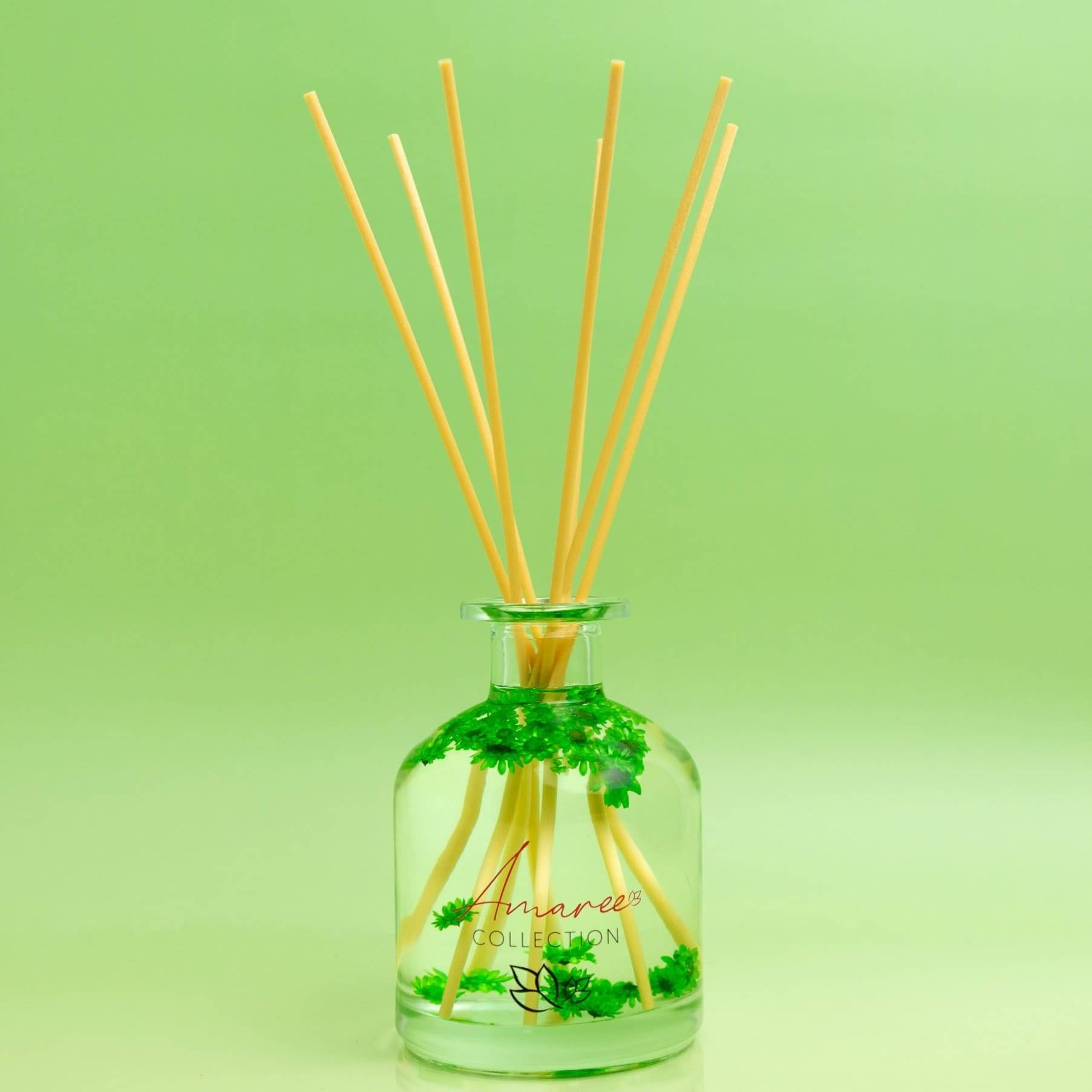 Coconut Lime Reed Diffuser 250ml displayed in a clear glass bottle with reeds and greenery, ideal for tropical ambiance.