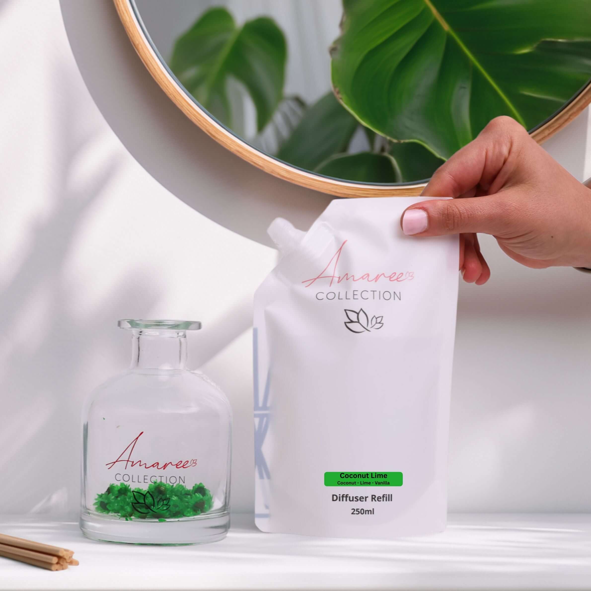 Coconut & Lime Reed Diffuser Refill 250ml placed beside diffuser bottle in a bright, tropical setting.