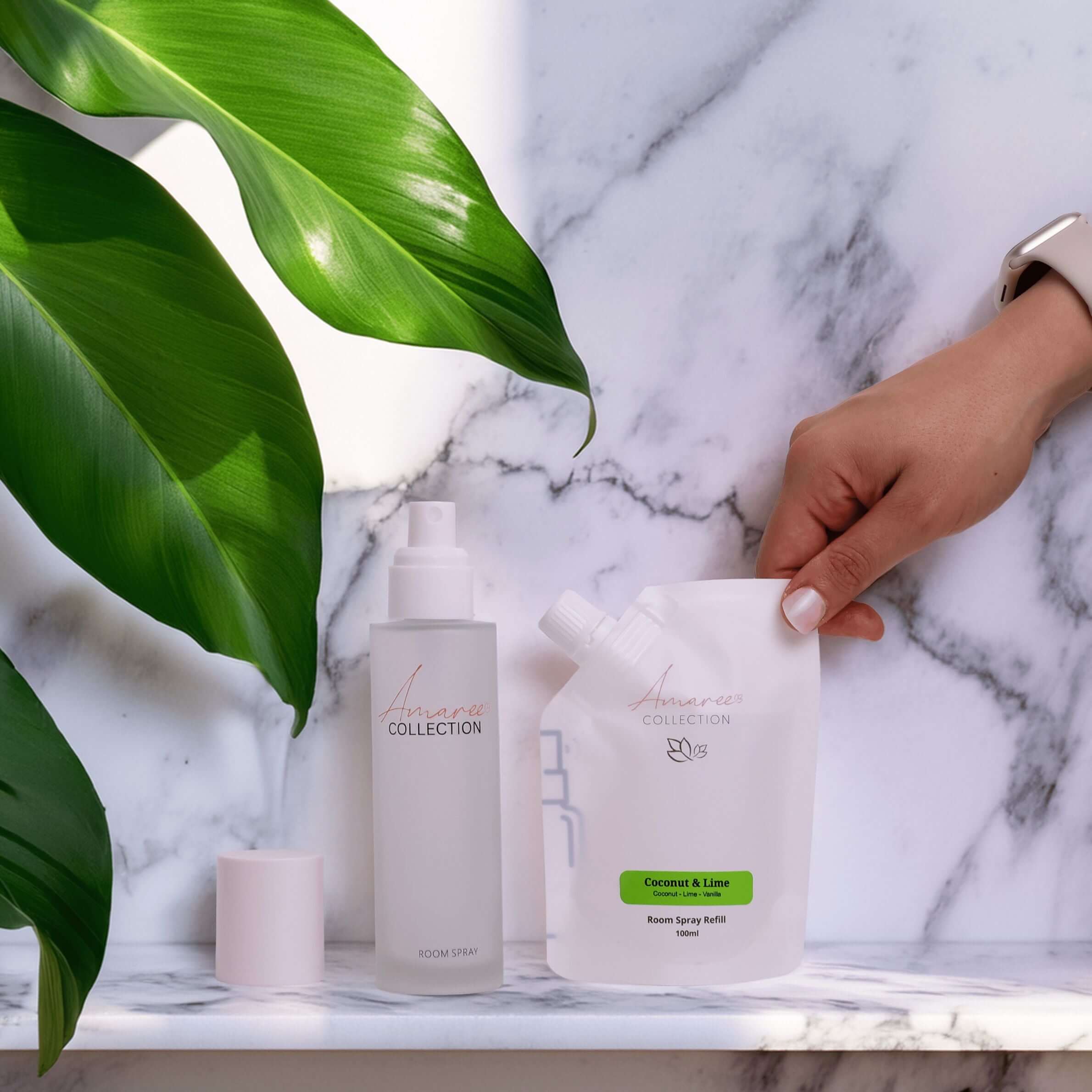 Coconut Lime Room Spray Refill 100ml with eco-friendly packaging and spray bottle on marble surface.