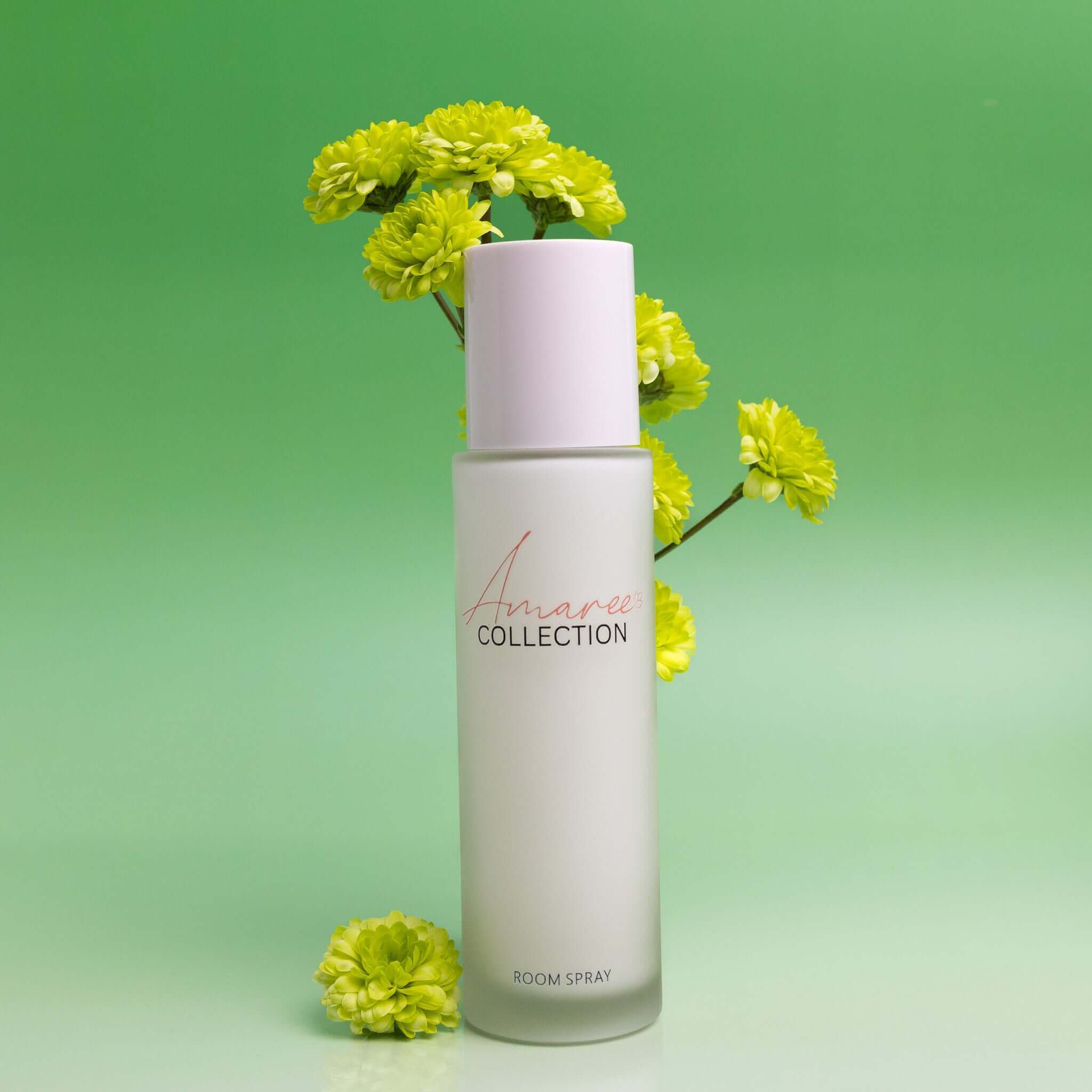 Lemongrass & Persian Lime Room Spray 100ml in a stylish bottle with fresh green background and vibrant flowers.