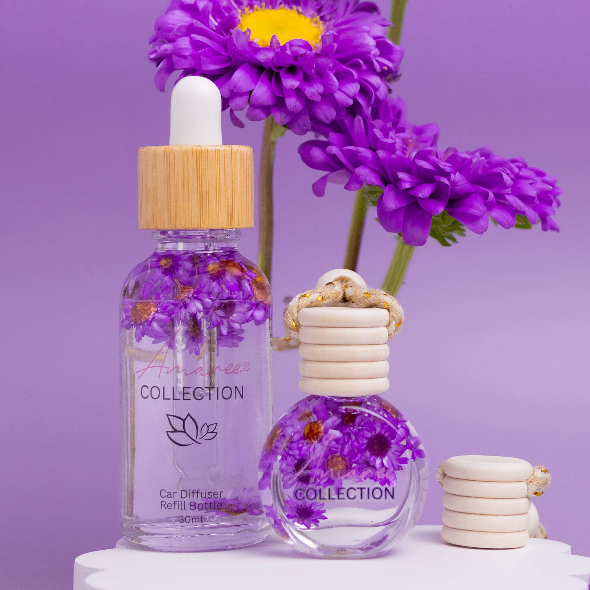 Japanese Honeysuckle Car Diffuser Kit with floral designs and refillable bottles on a purple background
