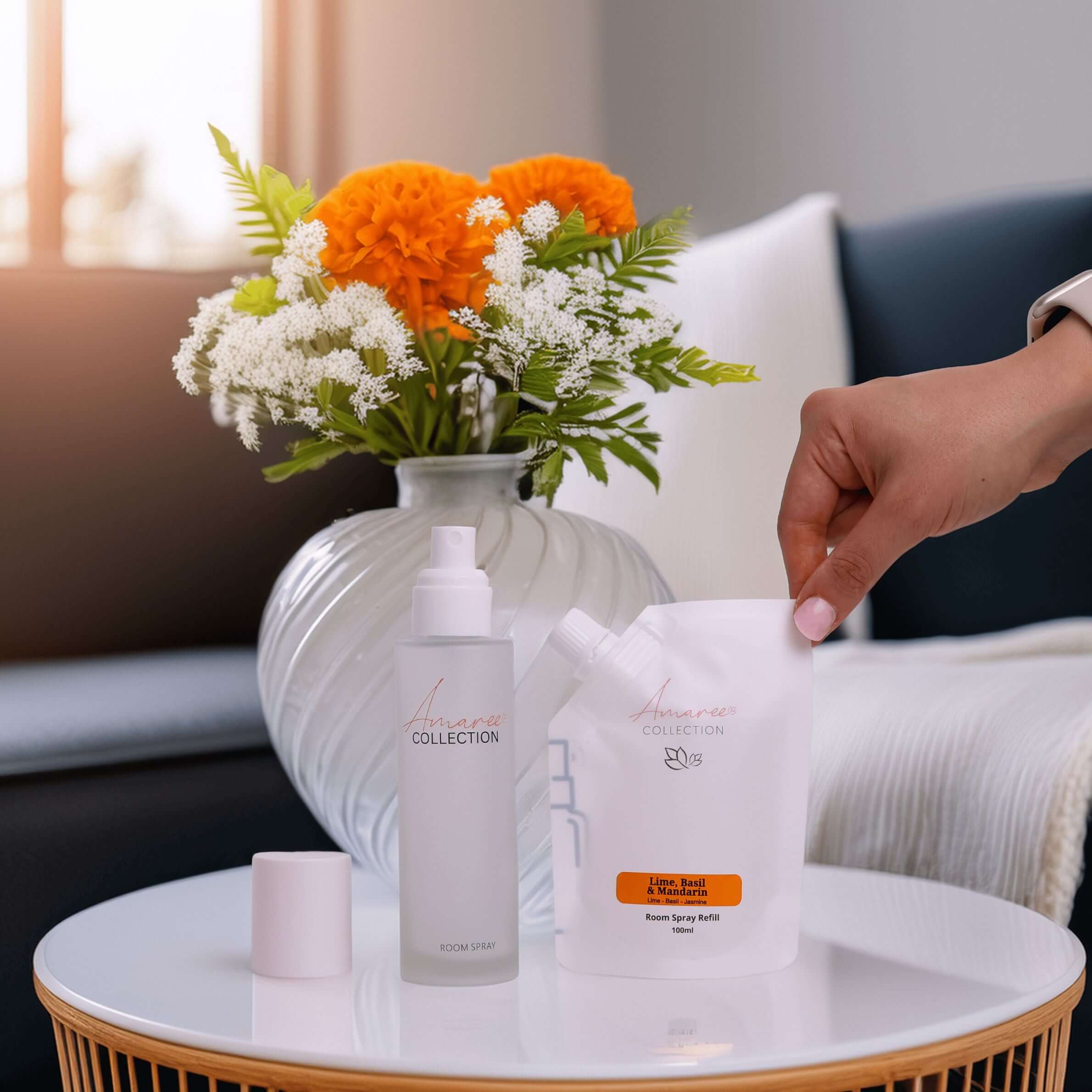 Lime Basil & Mandarin Room Spray Refill 100ml with vibrant flowers and room decor in a stylish living space