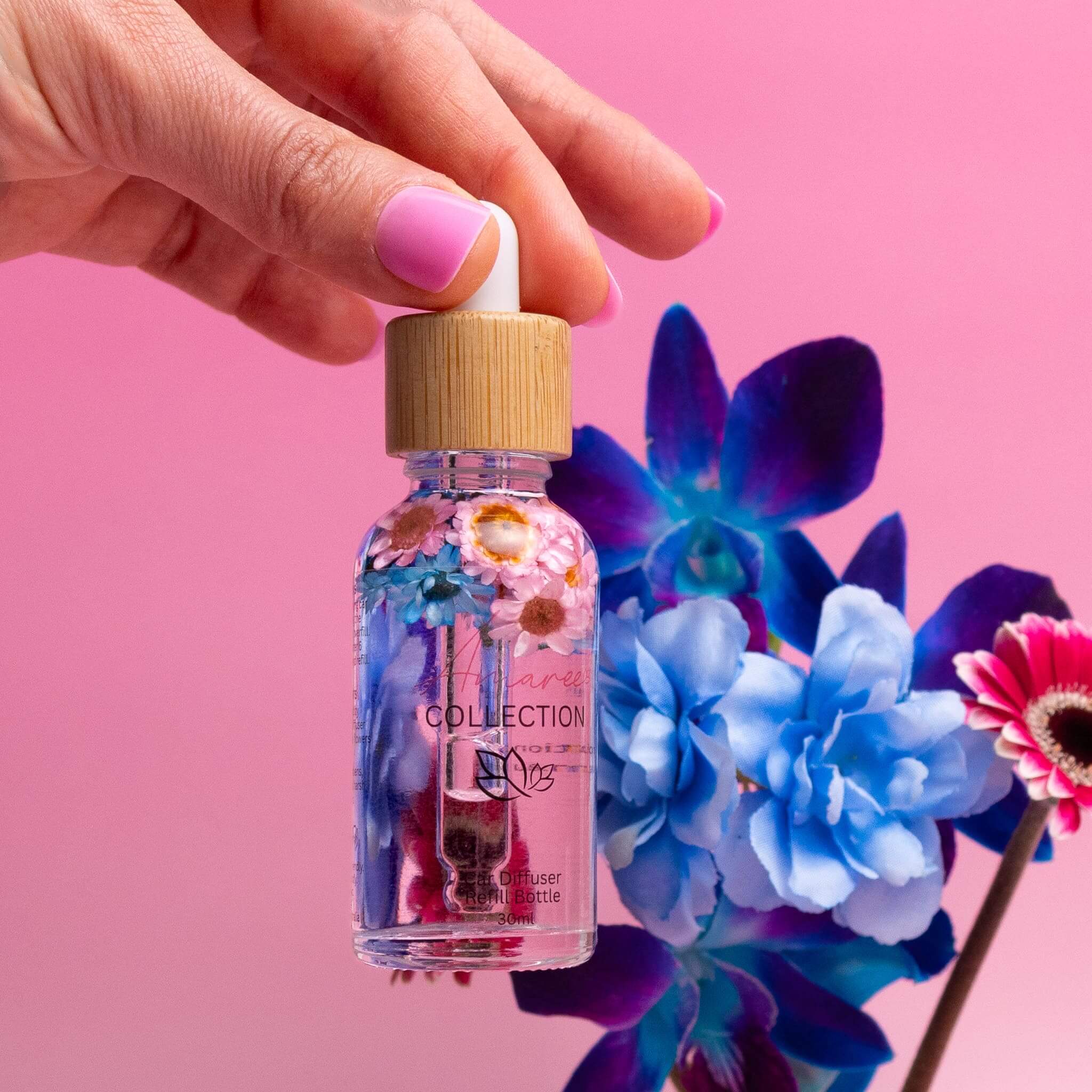 Pink Champagne & Exotic Fruits Car Diffuser Kit with a beautiful floral design on a pink background.