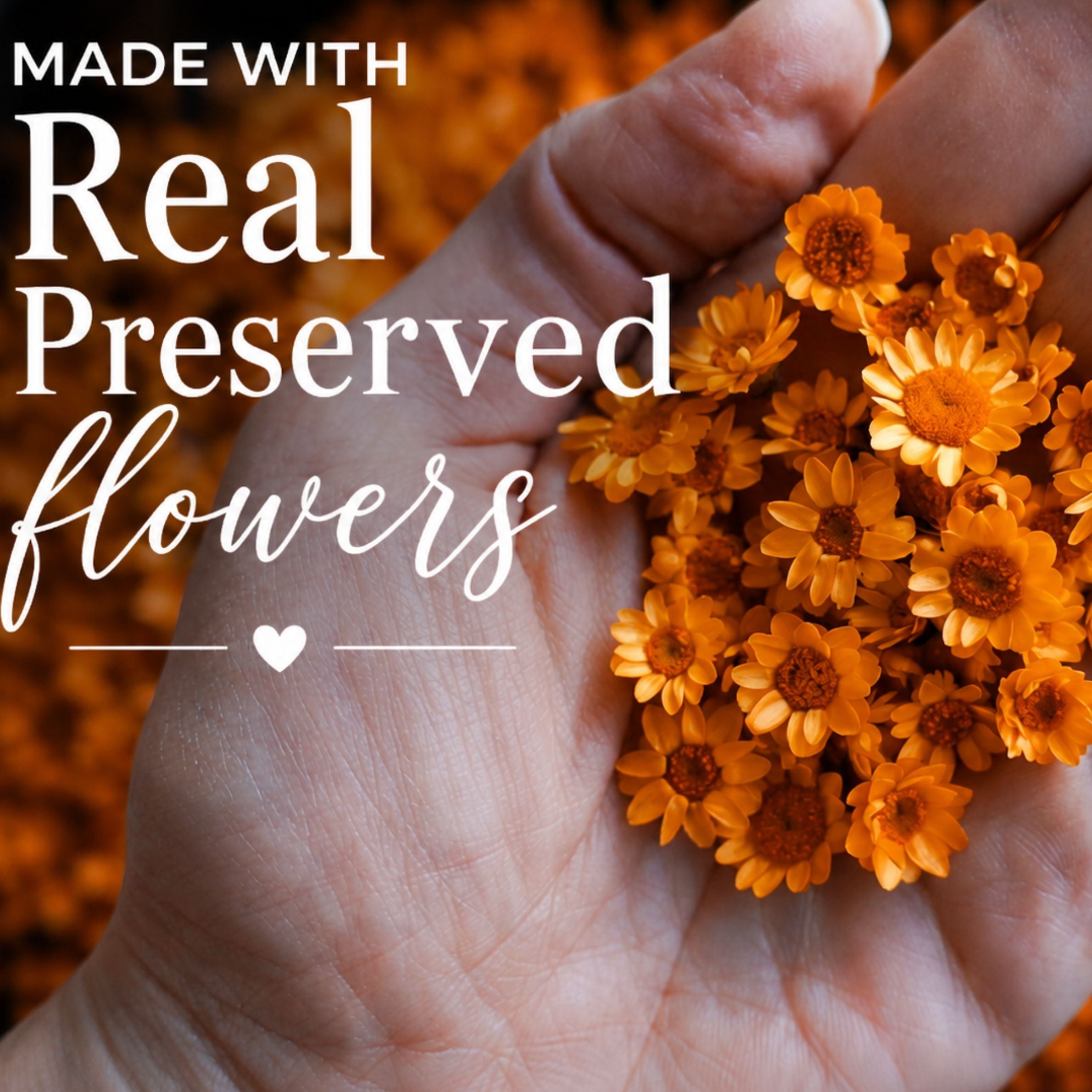 Hand holding a small bouquet of preserved orange flowers with text &