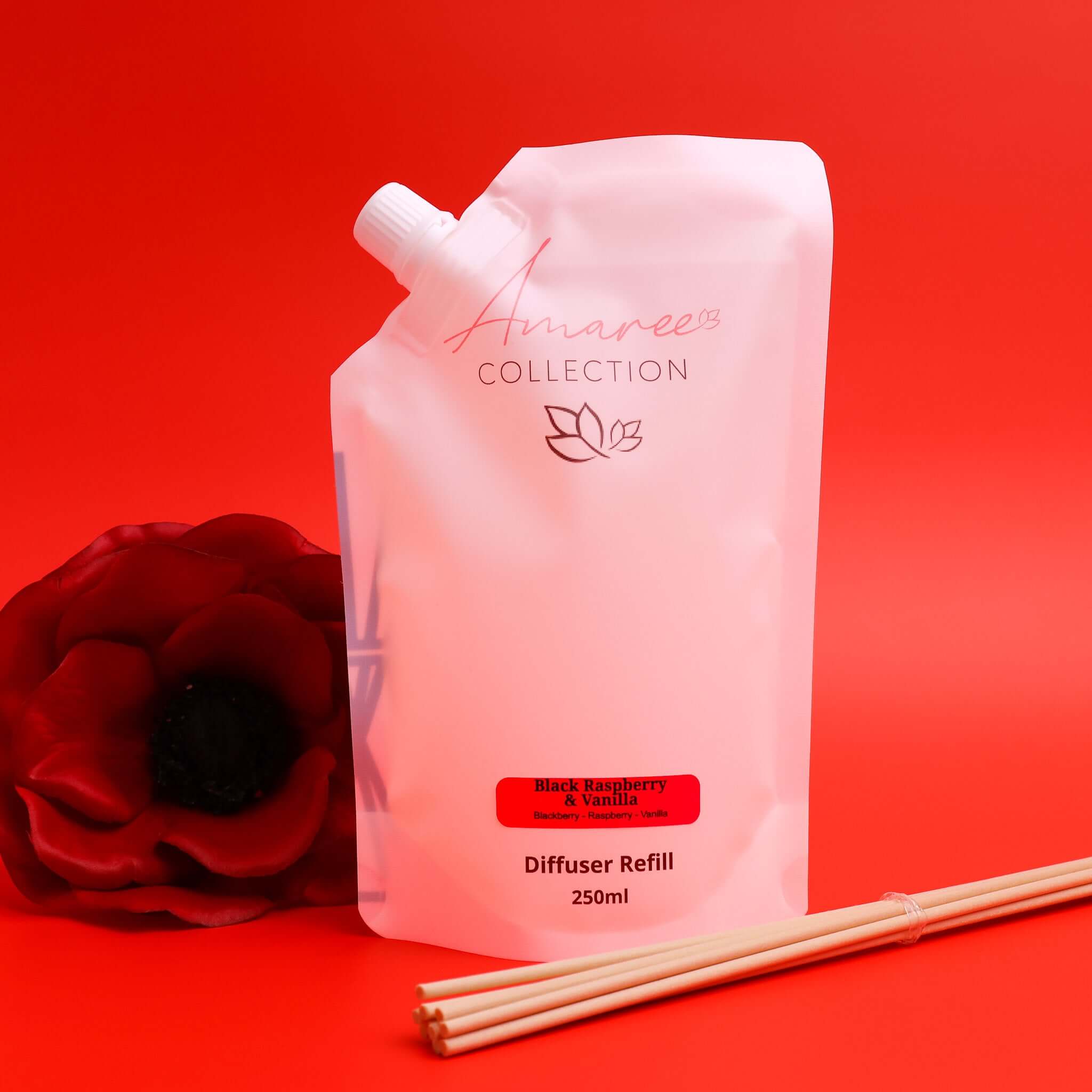 black raspberry vanilla reed diffuser refill 250ml pouch with reeds on red background