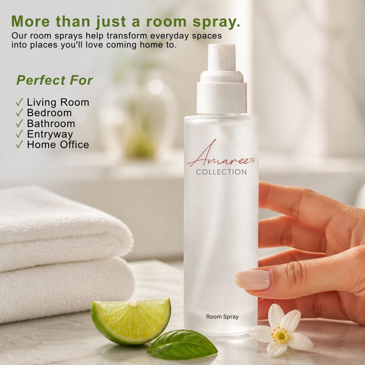A hand holds a frosted white bottle of Amaree Collection Room Spray against a bright, softly blurred bathroom background, with folded white towels, a lime wedge, green leaves, and a small white flower nearby. Text on the left describes room spray benefits and usage scenarios.