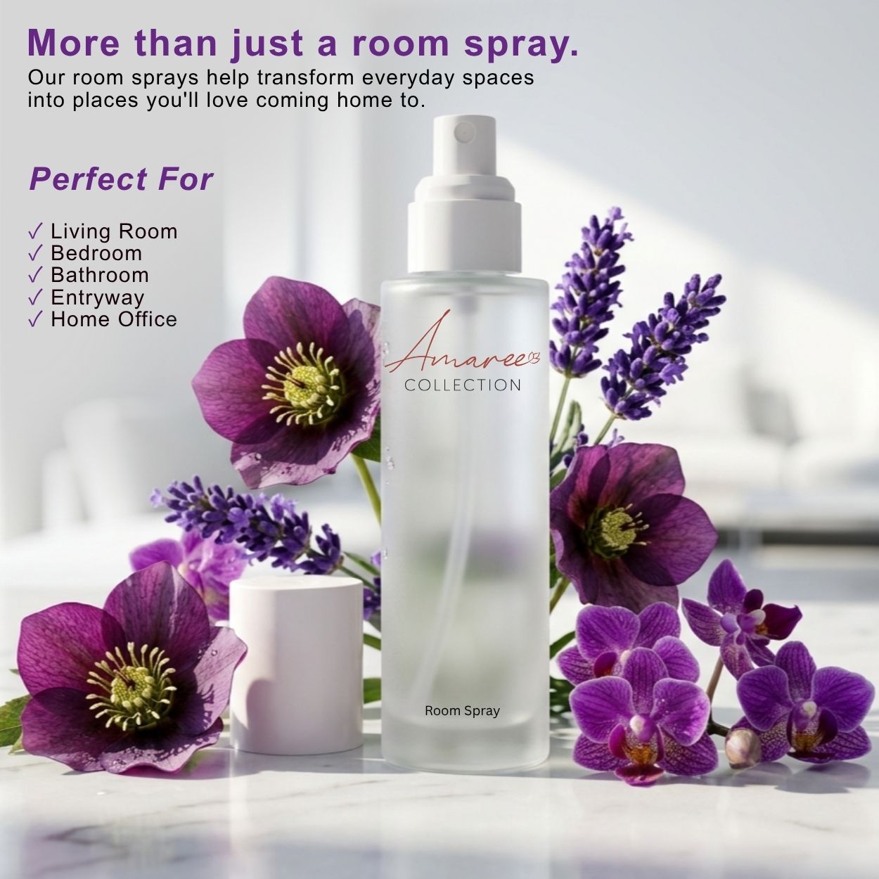A frosted glass room spray bottle with a white pump cap, surrounded by purple flowers and lavender sprigs on a light marble surface. Text on the left reads &