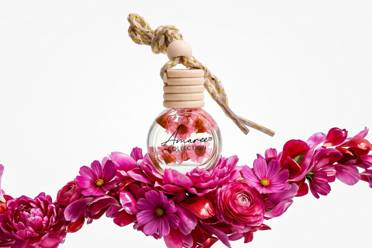 Pink floral Car Diffusers bottle with non-toxic pet-friendly fragrance oil and gerbera flowers on a pastel pink background
