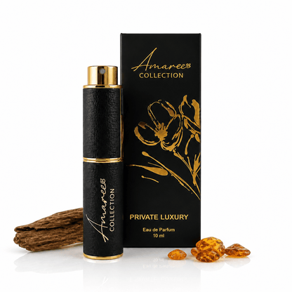 A 10 ml bottle of Amaree Collection Private Luxury Eau de Parfum next to its black and gold box, styled with a piece of wood and amber crystals on a white background.