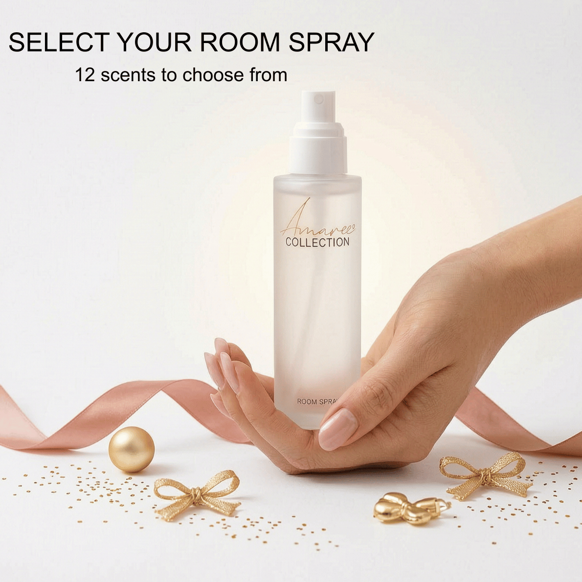 A hand holds a frosted room spray bottle from the Maison de Paris Collection, with decorative gold ribbons, bows, and confetti on a white surface. Text at the top reads &