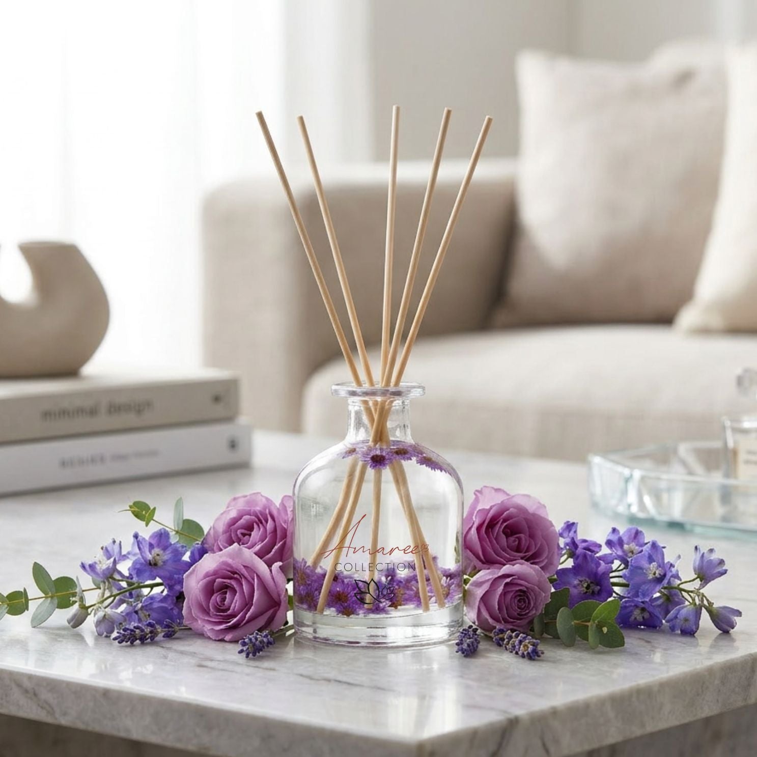 reed Diffuser with wooden sticks and flowers on a marble surface