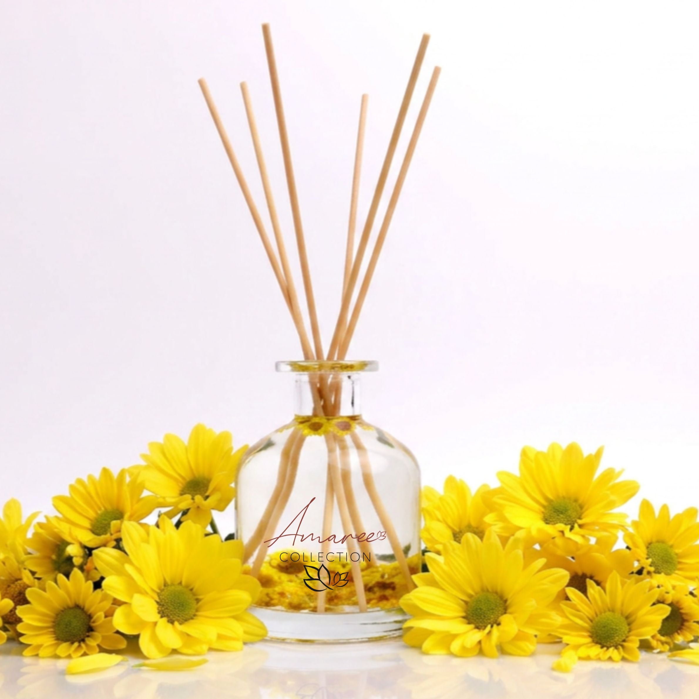 Reed diffuser with wooden sticks and yellow flowers on a light background