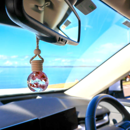 Lychee Peony Car Diffuser hanging from rear-view mirror, fruity vibrant car air freshener for cheerful light to medium scent