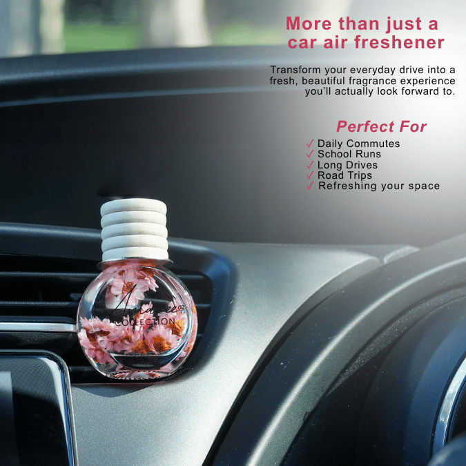 A round car air freshener bottle with a white ribbed cap, filled with pink and orange floral liquid, resting on a car dashboard. The image includes promotional text highlighting its use for daily commutes, school runs, and road trips.