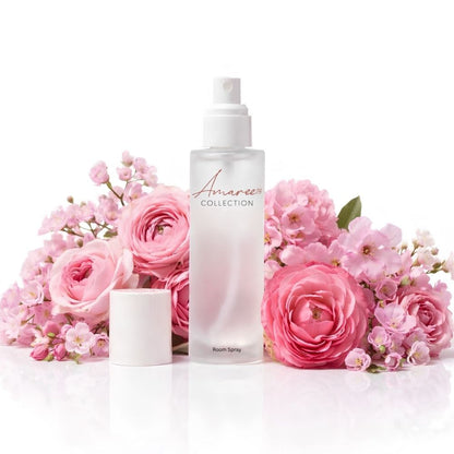 A frosted glass room spray bottle with a white spray top and cap, labeled &