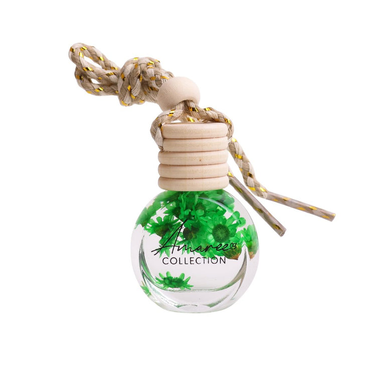Small bottle with green floral design and wooden top on a white background