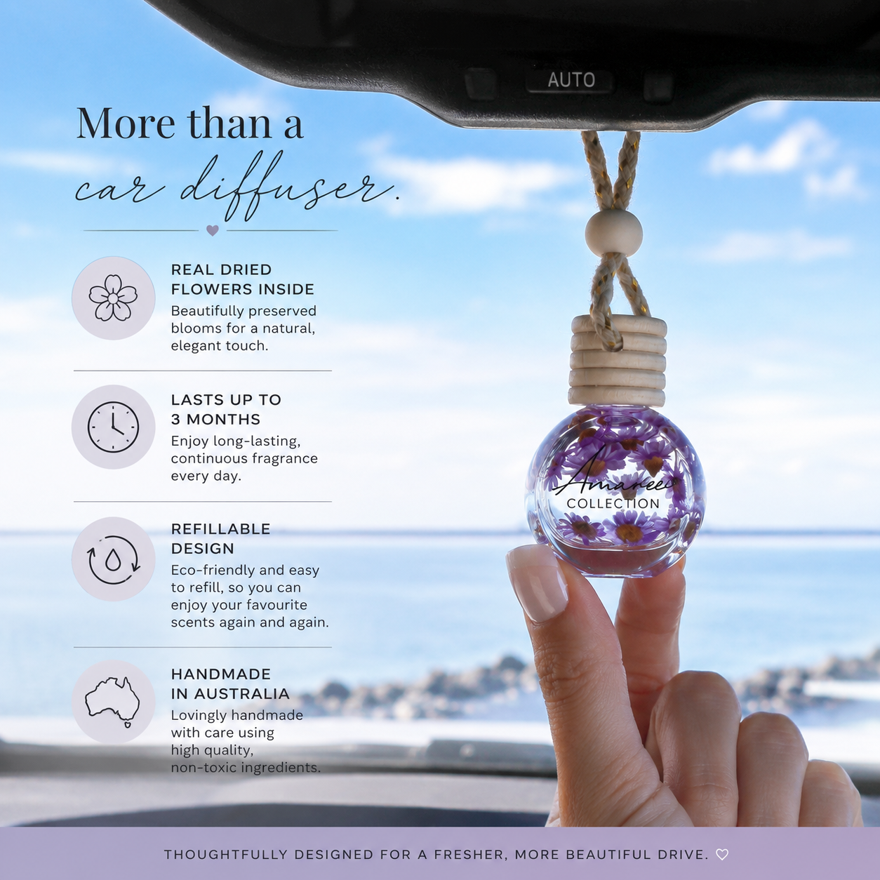Car diffuser with dried flowers, held by a hand, against a scenic background.