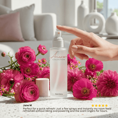 A hand points toward a frosted room spray bottle labeled &