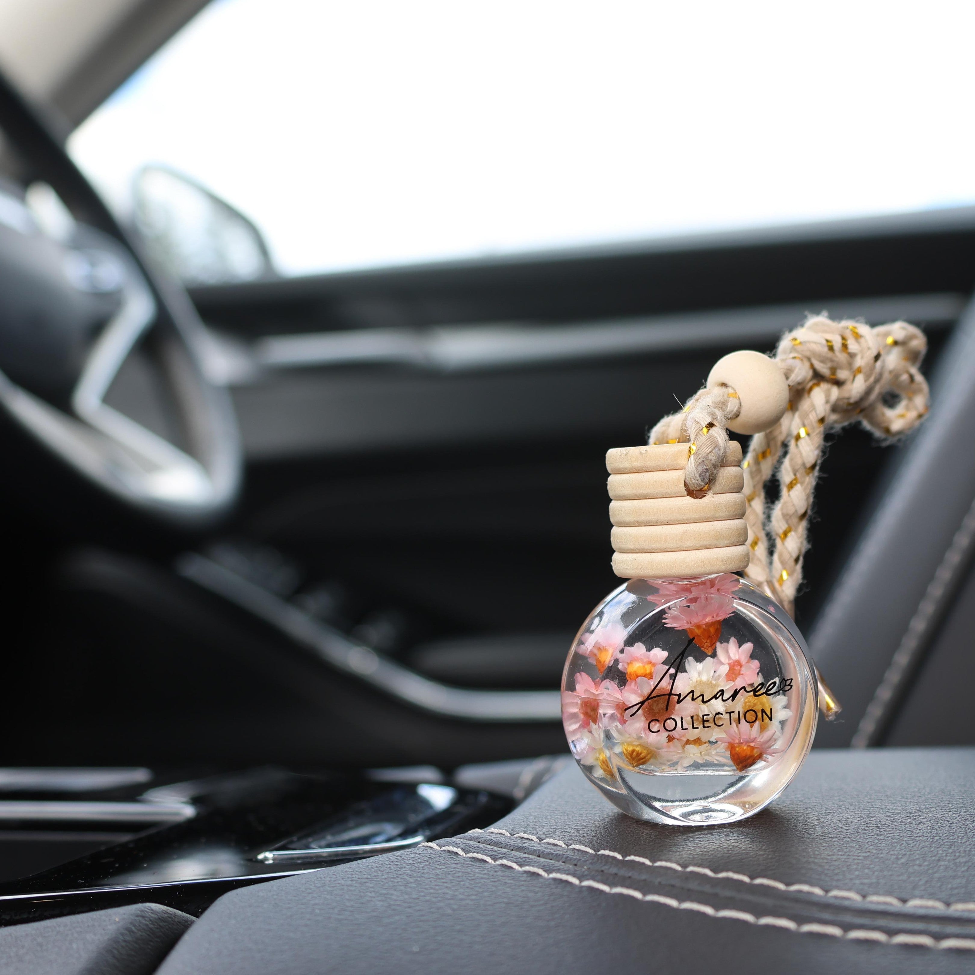 Car air freshener with decorative elements on a car dashboard