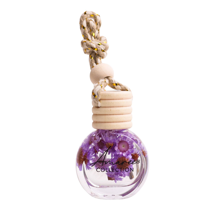 Decorative bottle with dried flowers and wooden top on a white background