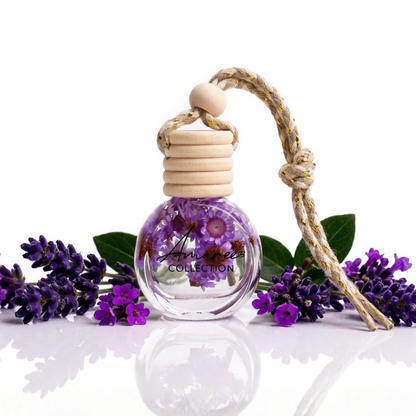 Small glass bottle with wooden cap, containing dried flowers, surrounded by lavender flowers on a white background.