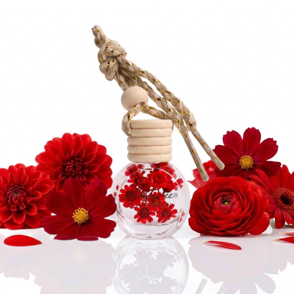 Perfume bottle with red flowers and a wooden cap on a white background