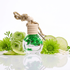 Perfume bottle with green floral design and lime slices on a white background