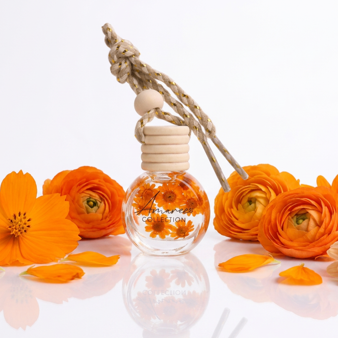 Perfume bottle with orange flowers and a wooden cap on a white background