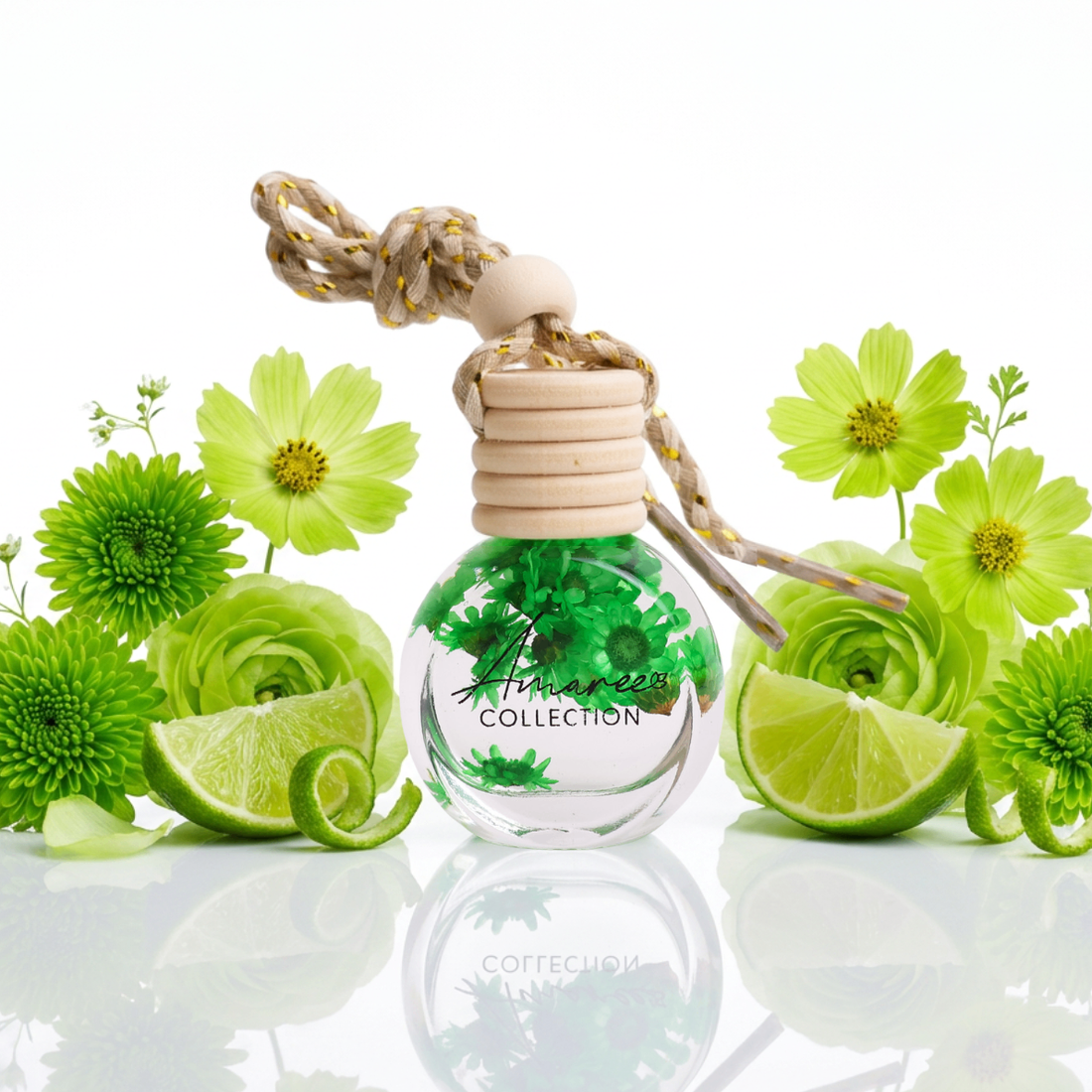 Perfume bottle with green floral design and lime slices on a white background