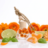 Car Perfume diffuser with floral design surrounded by orange flowers, lime, and orange slices on a white background