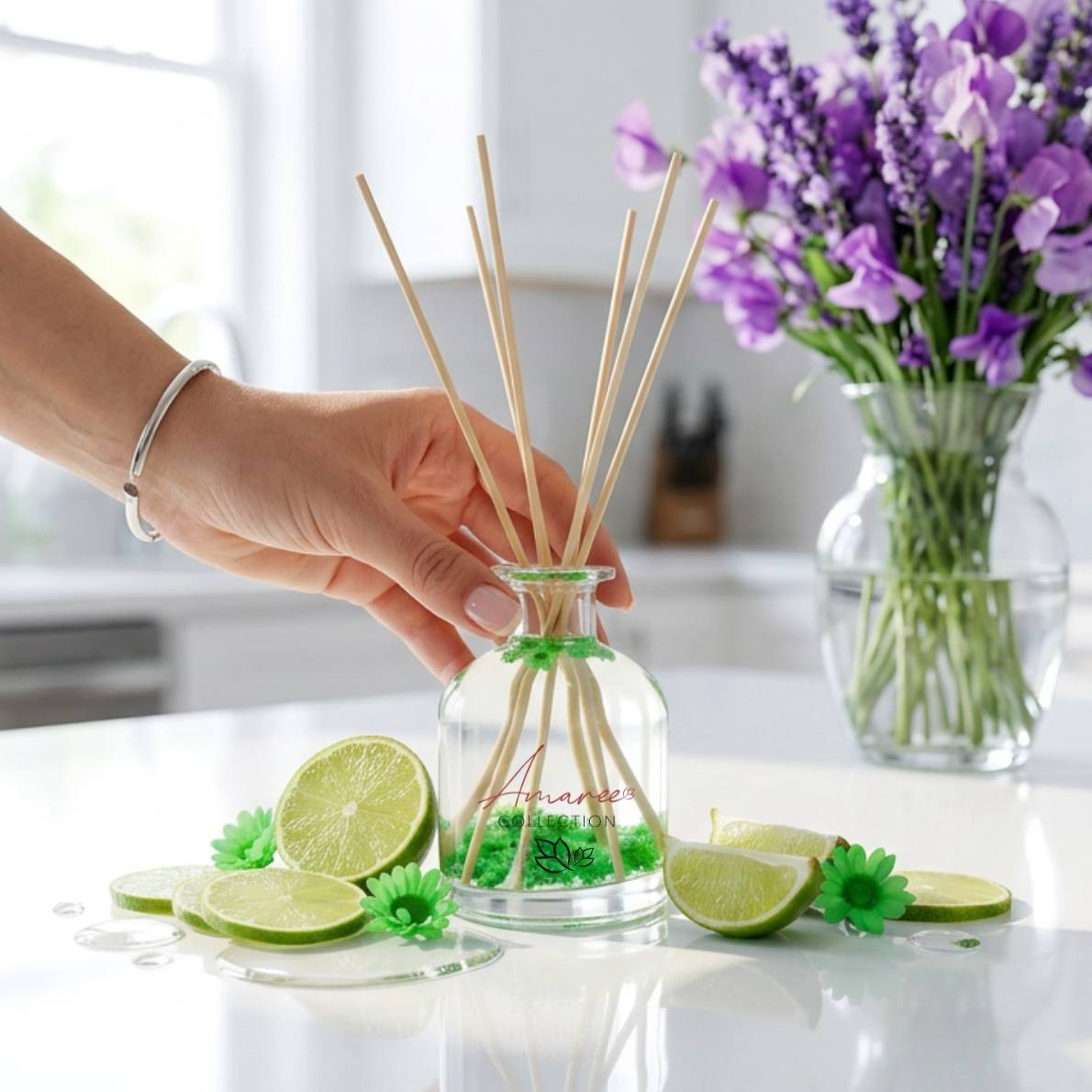 home fragrance styled in a home kitchen with green reed diffuser and case of purple flowers