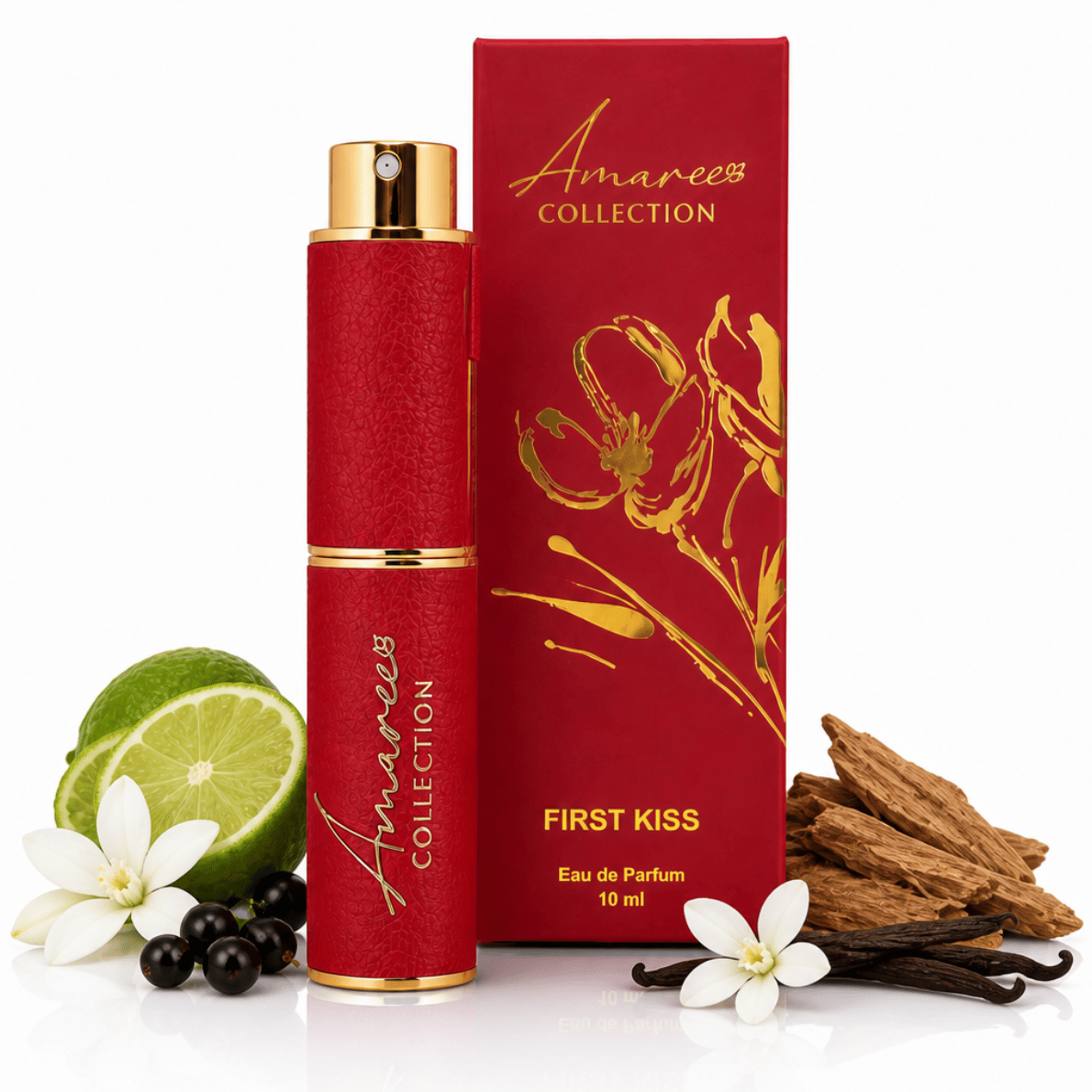 A 10 ml bottle and matching box of Amaree Collection First Kiss Eau de Parfum, styled with fresh ingredients including a lime, white flowers, blackberries, and vanilla beans on a white background.