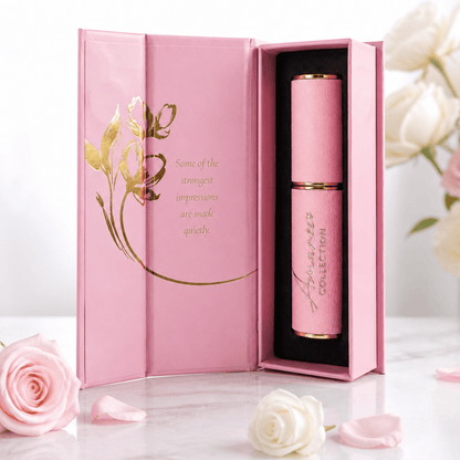 pink and gold refillable perfume case against a white background styled with pink and white roses in an elegant magnetic box