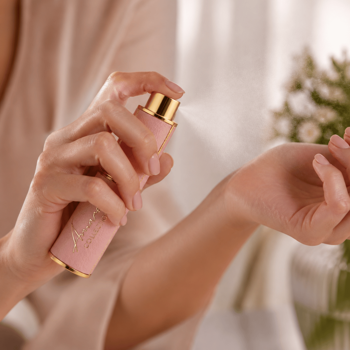 women gracefully spraying refillable perfume on her wrist