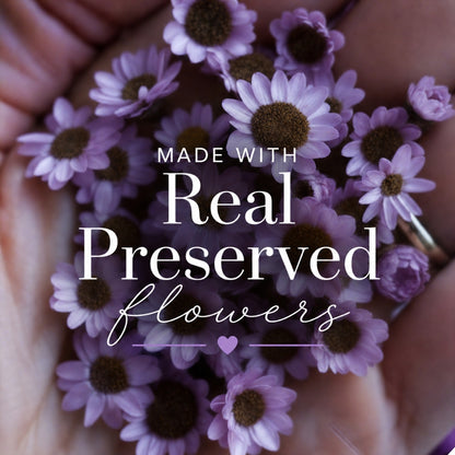 Purple flowers held in hands with text &