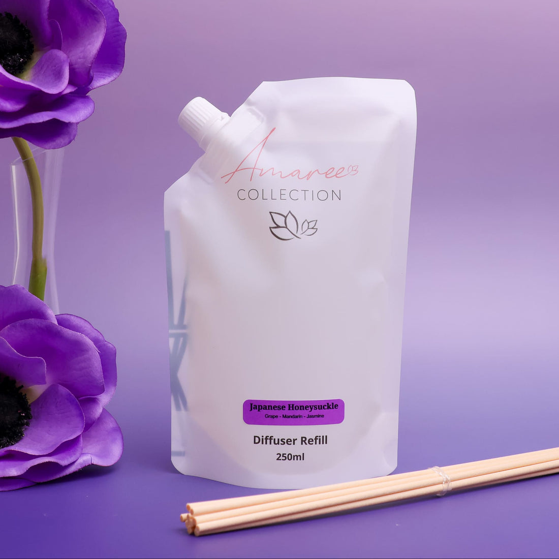 Japanese honeysuckle diffuser refill packaging with reeds and flowers on a purple background