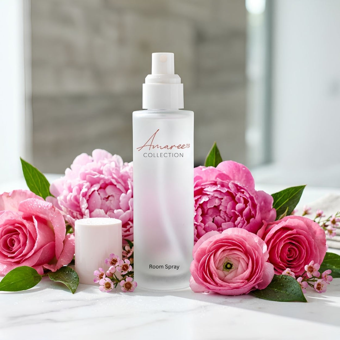 A frosted glass room spray bottle with a white pump dispenser, branded &