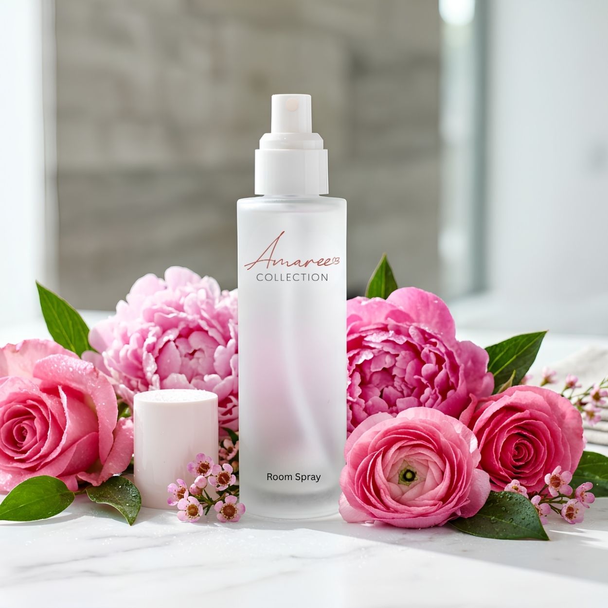 A frosted glass room spray bottle with a white pump dispenser, branded &