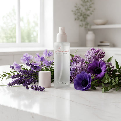 A frosted glass room spray bottle labeled &
