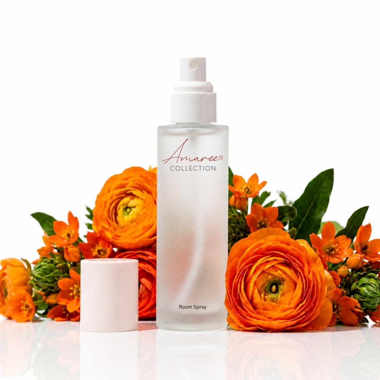 A frosted glass room spray bottle with a white pump and detached white cap, branded &